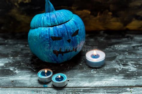 Horribly Blue Halloween Painted Blue Pumpkins And Candles Stock Photo