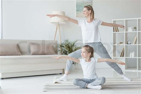 Mother And Daughter Practicing Yoga Together Stock Image Colourbox
