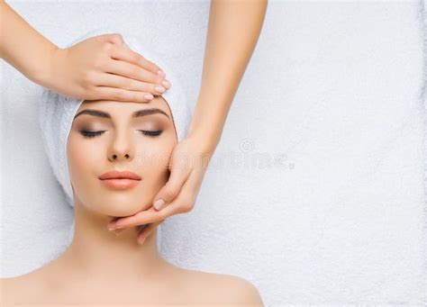 Young And Healthy Woman Gets Massage Treatments For Face Skin And Neck In The Spa Salon Health
