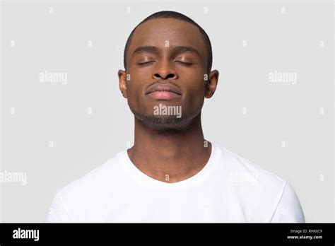 Calm Mindful African American Man Enjoy Taking Deep Breath Stock Photo