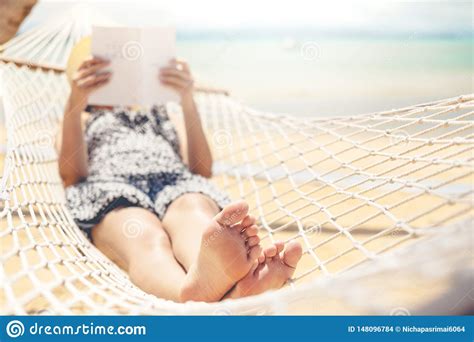 Woman Reading A Book On Hammock Beach In Free Time Summer Holiday Stock