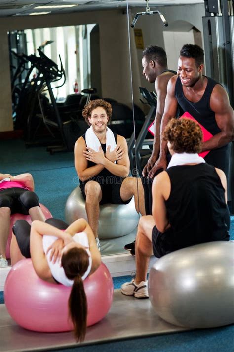 Trainer Instructing Gym Clients Stock Image Image Of Male Machines