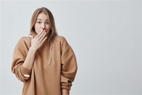 Free Photo Shy Young Woman Close Up Portrait Woman With Blonde Hair Looking Ashamed Or Shy