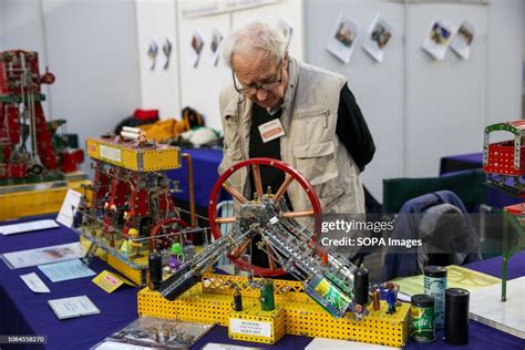 A Man Is Seen Viewing A Meccano Set At The Annual London Model News