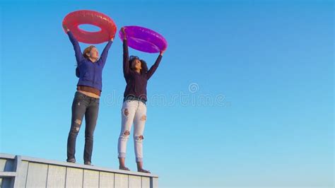 two women friends with pool tubes at the beach stock footage video of lifestyle couple 257818750