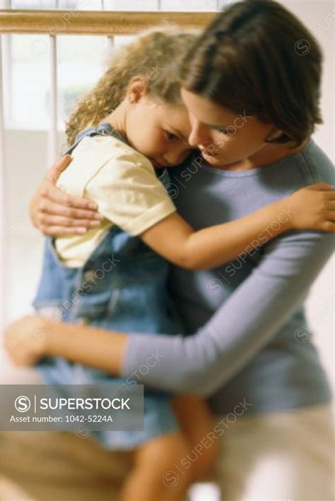 Mother Hugging Her Daughter Superstock
