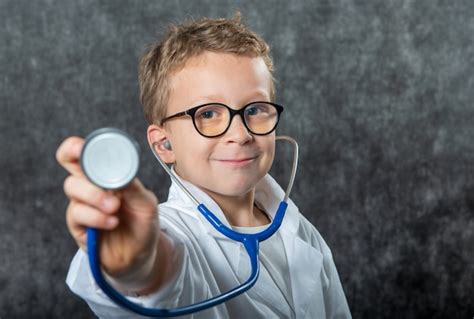 Premium Photo Cute Kid Boy Wear Medical Uniform Playing Doctor Portrait