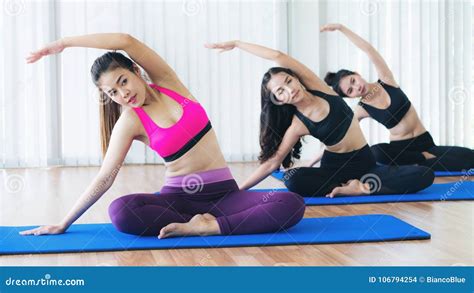 Women Practicing Yoga Pose In Fitness Gym Class Stock Photo Image Of