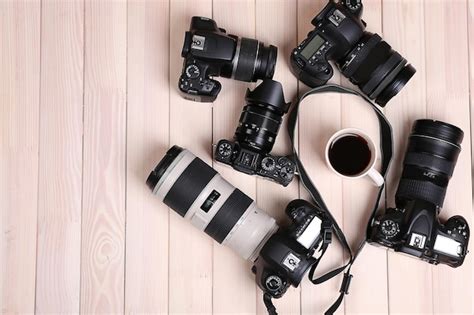 Premium Photo Modern Cameras And Cup Of Coffee On Wooden Table Top View