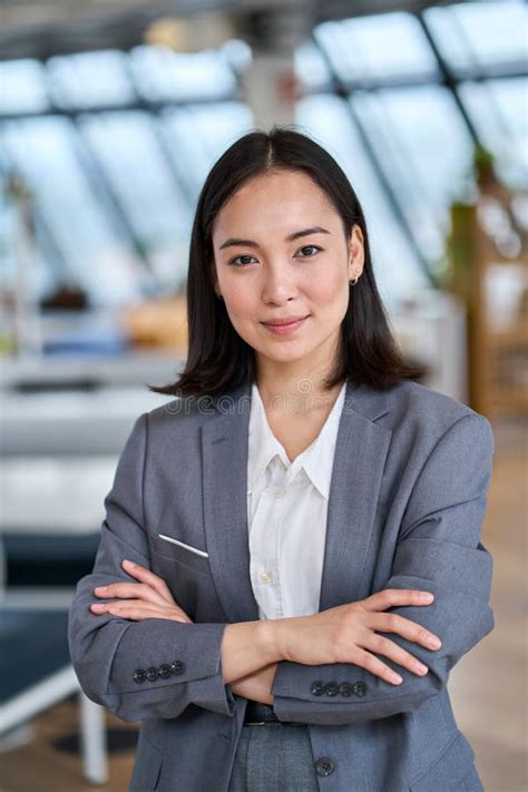 Young Confident Asian Business Woman Standing In Office Vertical