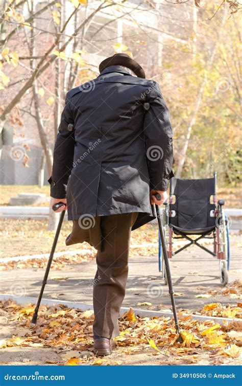 Handicapped One Legged Man Walking On Crutches Royalty Free Stock Image