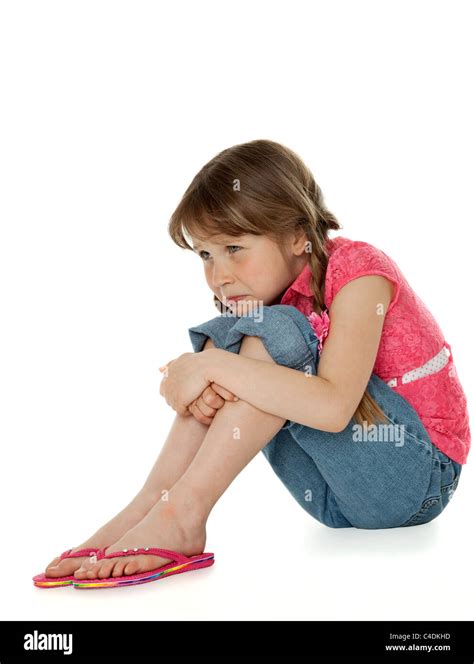 Young Girl Sitting Hugging Knees Sad Facial Expression On White