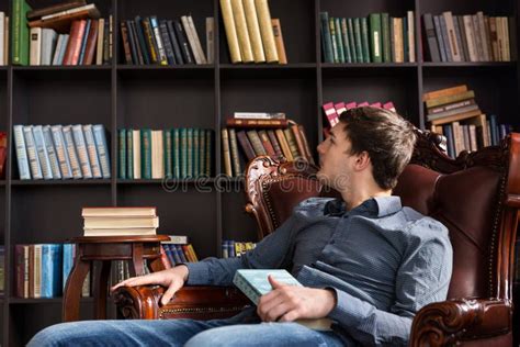 Young Man Checking Out Books In A Library Stock Photo Image Of Alone