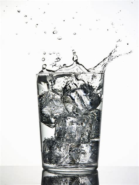 Ice Cubes Splashing Into Fizzy Drink Photograph By Walter Zerla