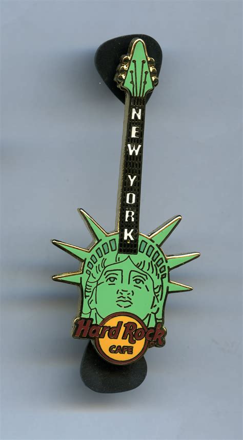 A Statue Of Liberty Pin With The Word New York On It S Back And Head