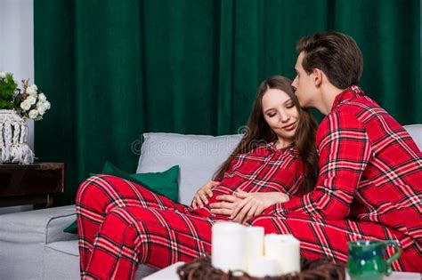 Husband And Wife Pose At Pregnancy Session Wearing Identical Clothes