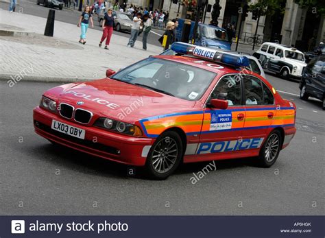 Here's why police cars are better than normal cars. red bmw police car driving through the city of london ...