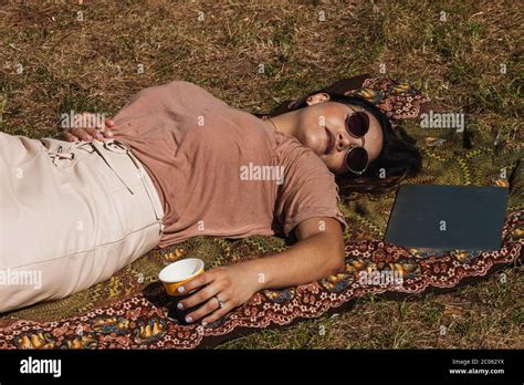 Latin Woman Stretched Out On The Grass After Work Relax Concept Stock