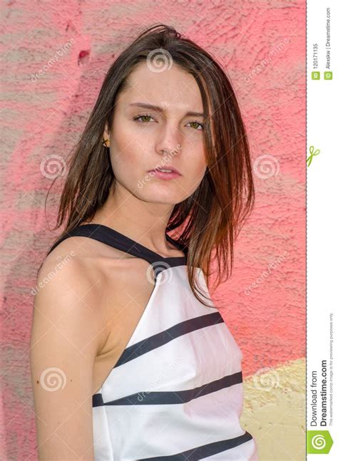 Brunette Girl With Long Hair Posing Against Graffiti Background Stock