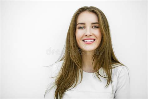 Beautiful Young Happy Woman Posing Against A White Wall Stock Image