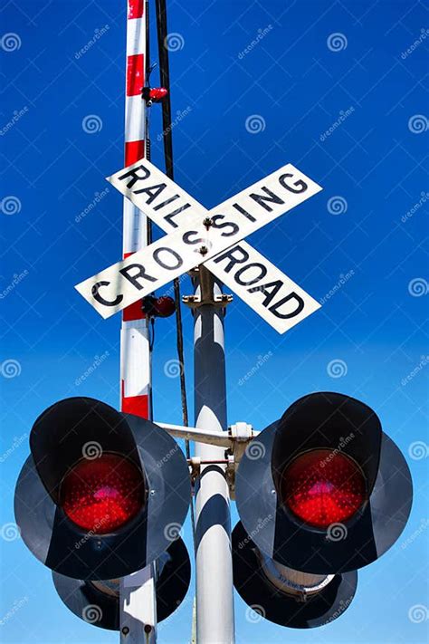 Railroad Train Level Crossing With Crossbuck Sign Gate And Flashing