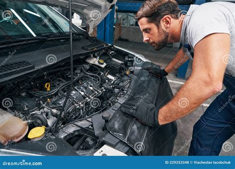 Young Attentive Repairman Is Examining Car Engine Stock Photo Image