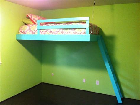A Bunk Bed Sitting In The Corner Of A Room With Green Walls And Black