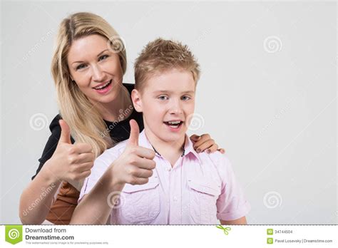 Mother And Son With Blond Hair Doing Thumbs Up Stock