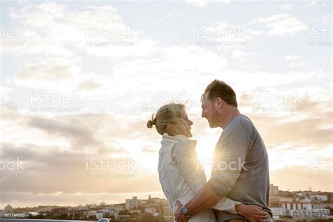 Loving Mature Couple Embracing In Sunlight Bondi Beach Stock Photo