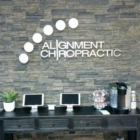 Custom Floating Brushed Metal Logo On Stone Wall Chiropractic Office