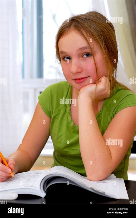 Young School Girl Doing Homework At Her Desk Stock Photo Alamy