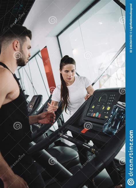 Attractive Trainer Instructing Young Sportsman Standing Stock Photo