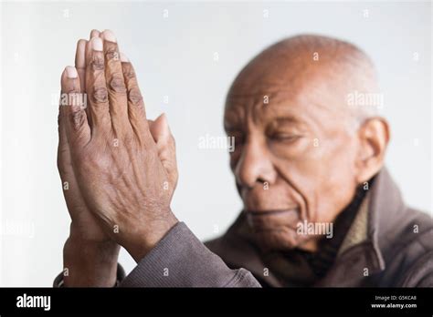 Older Black Man Praying With Hands Clasped Stock Photo Alamy