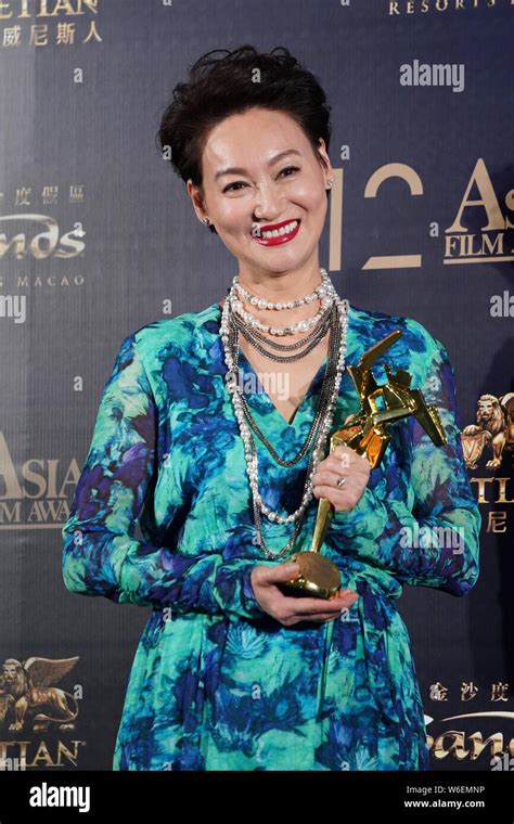 Hong Kong Actress Kara Hui Ying Hung Holds Up Her Trophy After Winning