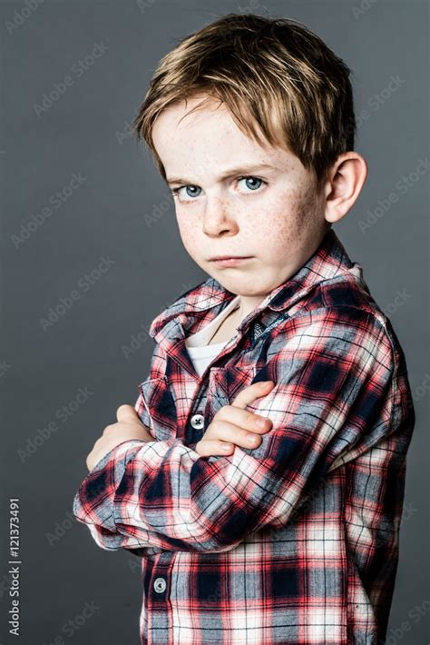 Upset Little Child Standing Pouting And Sulking To Express Attitude