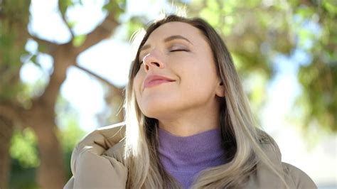 Premium Photo Young Blonde Woman Breathing With Closed Eyes At Park