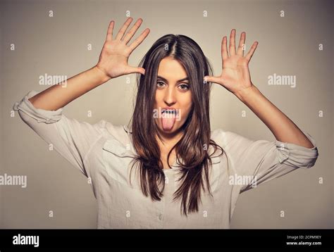 Young Pretty Woman With Funny Face Mocking Someone Sticking Her Tongue