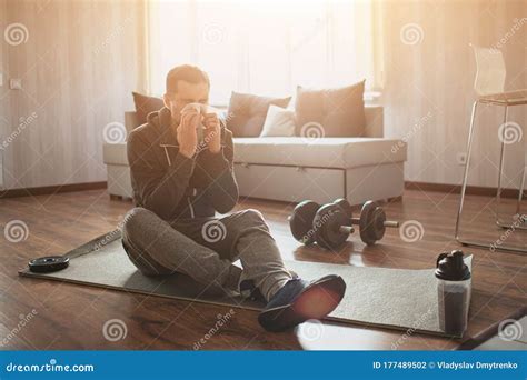 Young Ordinary Man Go In For Sport At Home Picture Of Spot Beginner Sitting On Mat And Sneezing