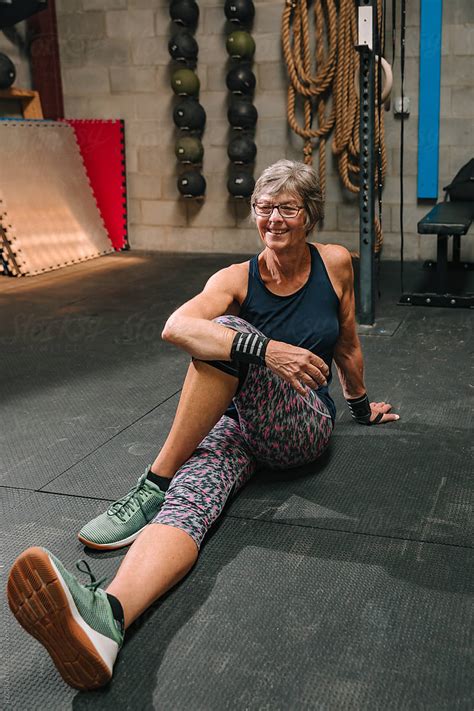 Senior Woman Stretches At Gym By Stocksy Contributor RZCREATIVE