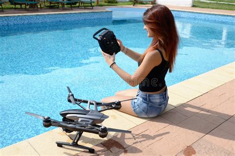 Girl Fly Drone With Remote Control By The Swimming Pool Stock Image