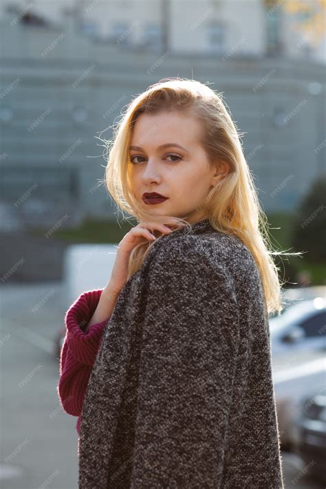 Premium Photo Magnificent Blonde Model Wearing Coat And Sweater Posing With Soft Backlight At