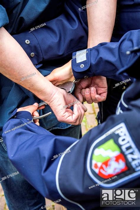 Police Officer Putting Handcuffs On An Offender NRW Police North Rhine Westphalia Germany