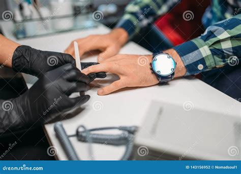 Beautician Polishing Nails To Male Client In Salon Stock Photo Image