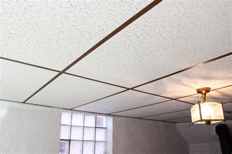 Learn how to install drop ceiling tiles into the ceiling grid with this video @ www.strictlyceilings.com. Basement Drop Ceiling Makeover with Home Depot | Sarah & Nick