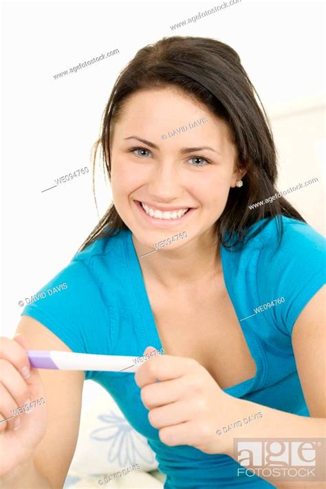 Young Caucasian Woman Holding A Pregnancy Test Stock Photo Picture
