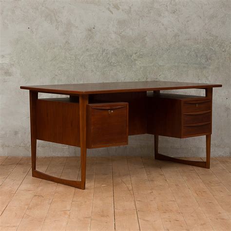 It has some scratches and crazing from age and some discoloration from the heat. Danish Mid-Century Modern Executive Desk - Futureantiques.us
