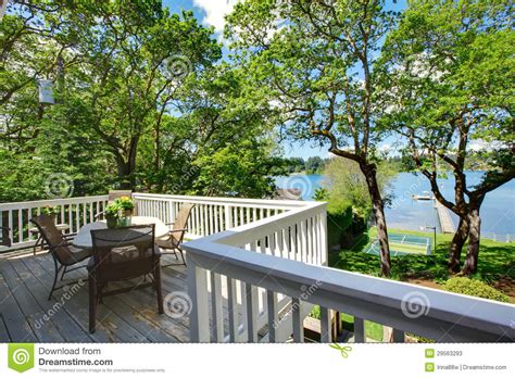 Large Balcony Home Exterior With Table And Chairs Lake