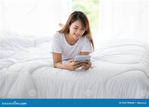 Portrait Of Beautiful Asian Woman Lying On Bed Enjoy Using Tablet At Home Young Lady Resting In