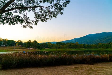 Beautiful Lake At Chiang Mai With Forested Mountain And Twilight Sky