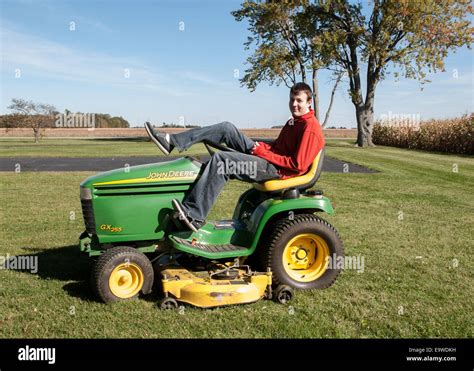 20s Man Sitting On A John Deere Gx255 Lawn Mower Stock Photo Alamy
